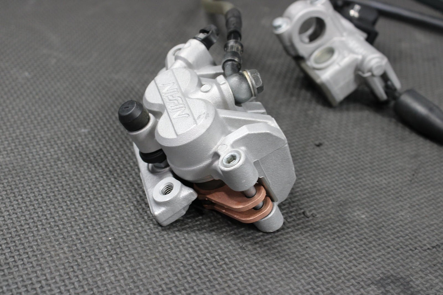 2009 Kawasaki KX250F OEM Nissin Front Brake Caliper Master Cylinder Complete - hggarage