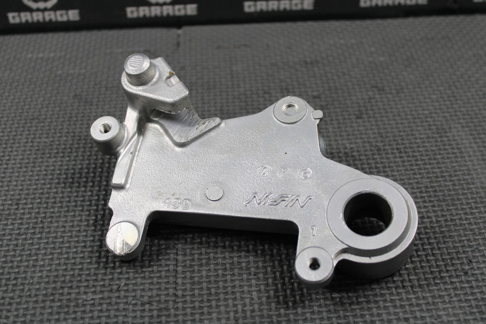 1995 SUZUKI 93 - 95 RMX250 OEM NISSIN REAR BRAKE CALIPER HANGER 69351 - 43D01 - hggarage